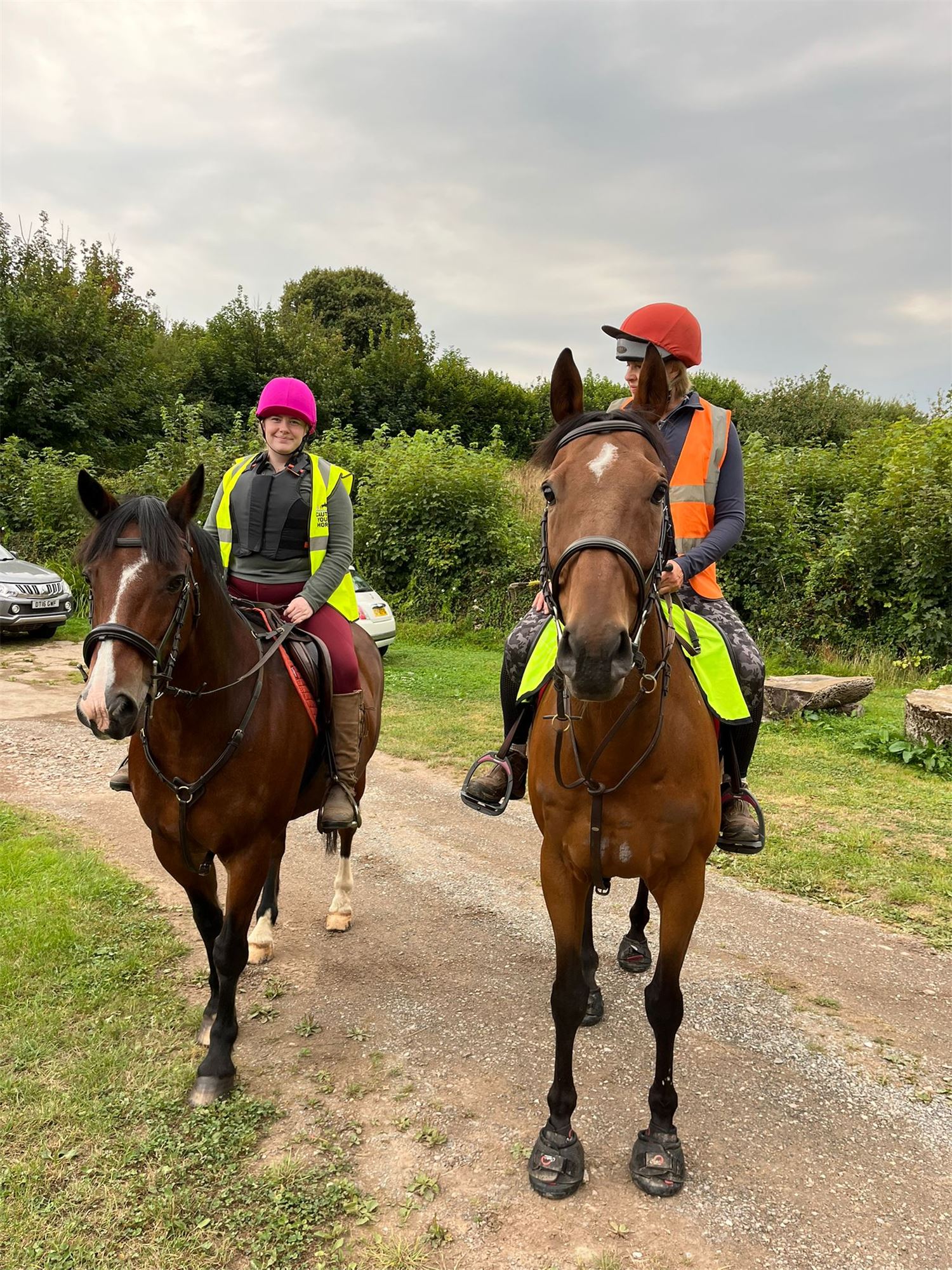 Two horses being ridden at Woodbury farm cottages
